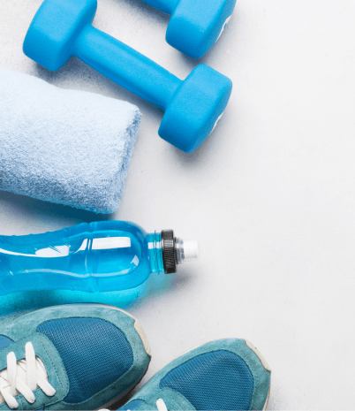 Image shows items associated with a fitness routine: towel, water bottle, sneakers, and weights.