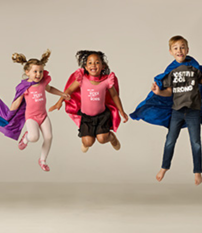 Two girls and a boy leap in the air as they perform a fun dance routine.