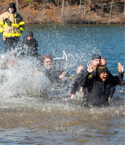 Police officers react as they dive into cold water at Oak Mountain State Park.