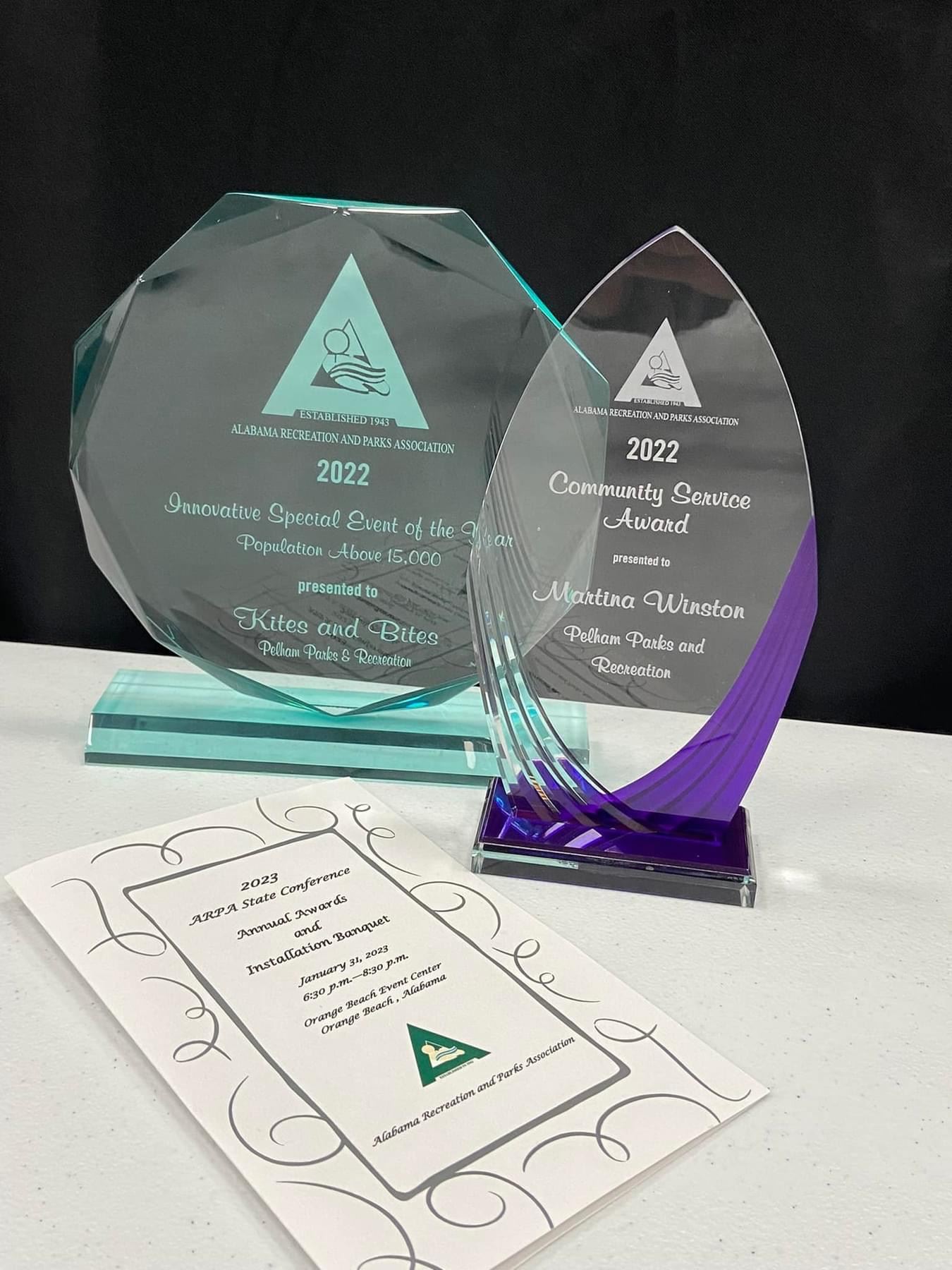 Two trophies and the program for awards ceremony.